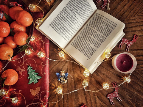 Holiday decor and an open book mark the advent of another holiday season. Photo by Sabina Sturzu on Unsplash.