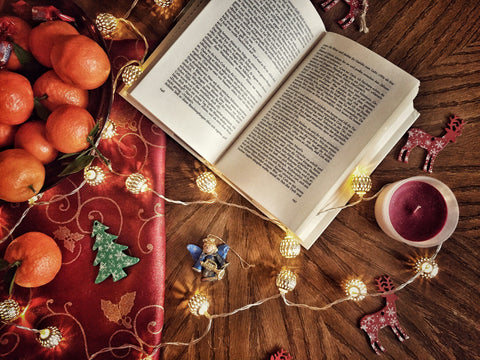 Holiday decor and an open book mark the advent of another holiday season. Photo by Sabina Sturzu on Unsplash. 
