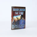 Hardcover book titled 'King Lopen The First of Alethkar' by Brandon Sanderson and Isaac Stewart on a neutral background